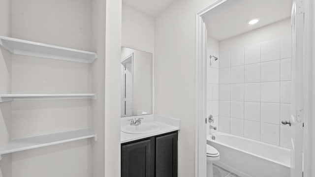 full bathroom featuring tiled shower / bath combo, vanity, and toilet