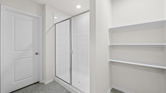 bathroom featuring a shower with shower door