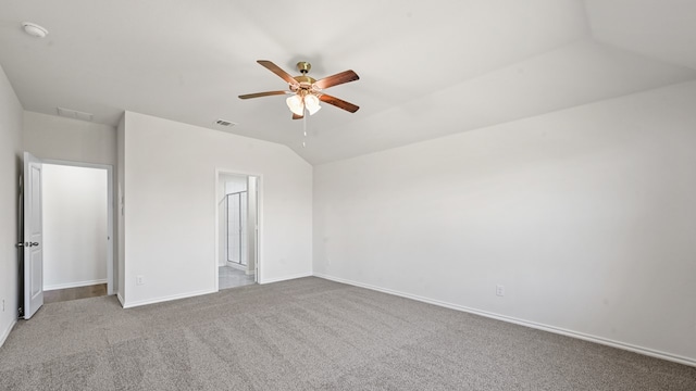 unfurnished bedroom with ceiling fan, light colored carpet, and lofted ceiling