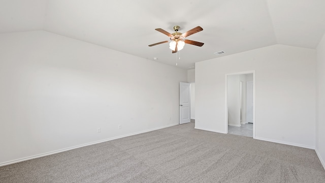 carpeted spare room with vaulted ceiling and ceiling fan