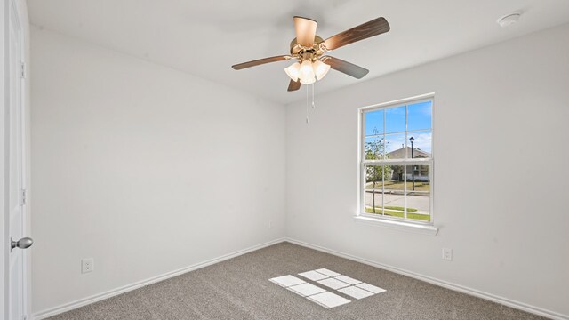 carpeted empty room featuring ceiling fan