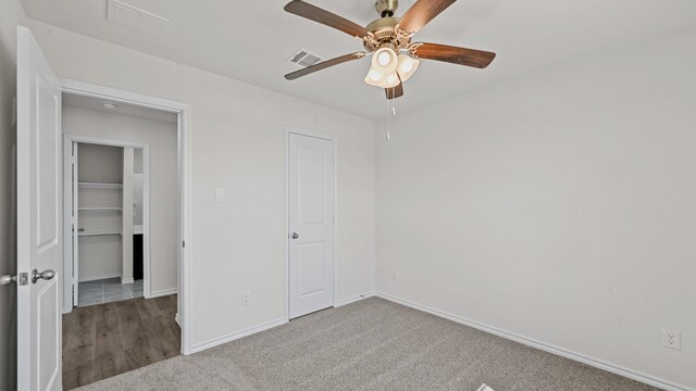 unfurnished bedroom with ceiling fan and carpet floors