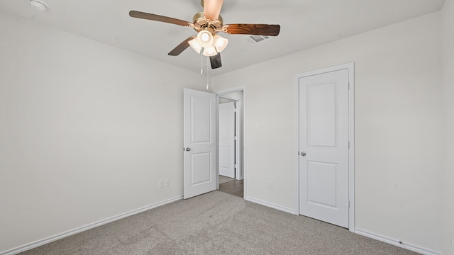 unfurnished bedroom with ceiling fan and light carpet