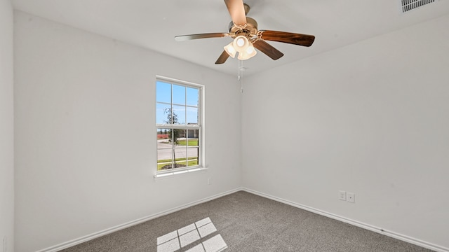 carpeted spare room featuring ceiling fan