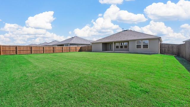 back of property featuring a lawn