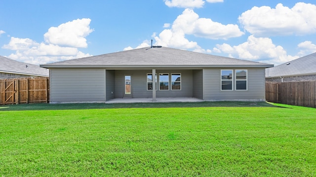 back of property with a lawn and a patio