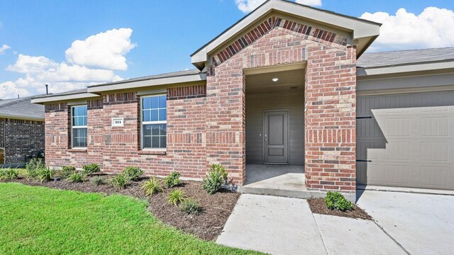 view of exterior entry with a garage