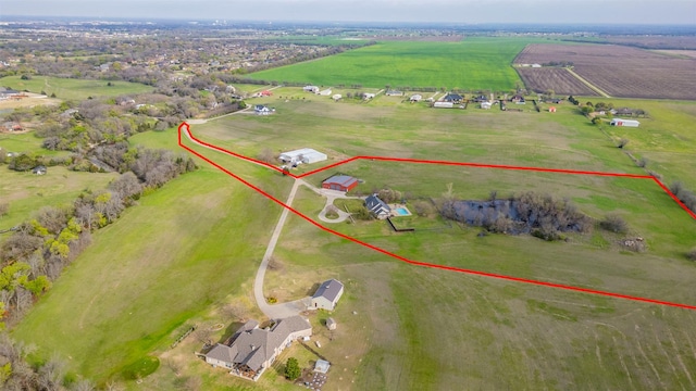 birds eye view of property with a rural view