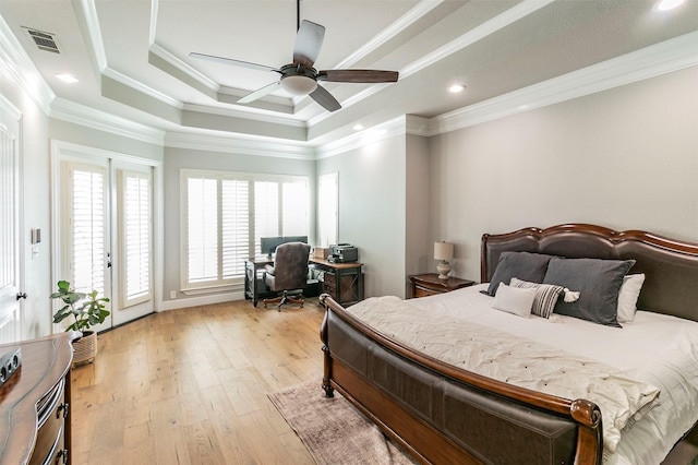 bedroom featuring access to exterior, ceiling fan, a raised ceiling, light hardwood / wood-style flooring, and crown molding