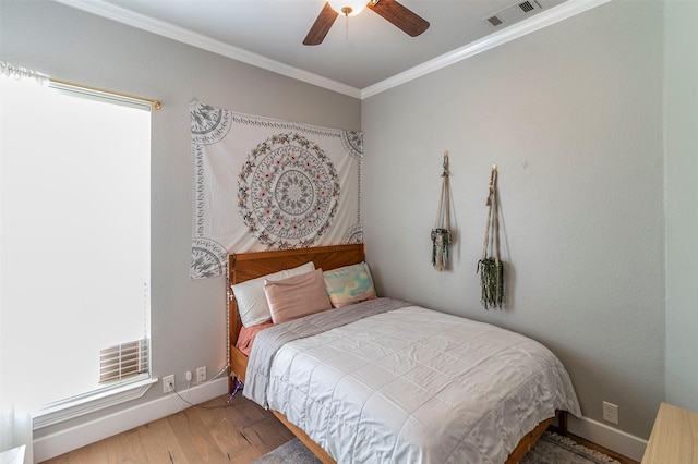 bedroom with ceiling fan, hardwood / wood-style flooring, and ornamental molding