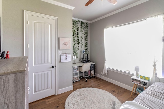 bedroom with ceiling fan, hardwood / wood-style floors, and ornamental molding