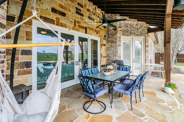 view of patio with area for grilling, ceiling fan, and french doors