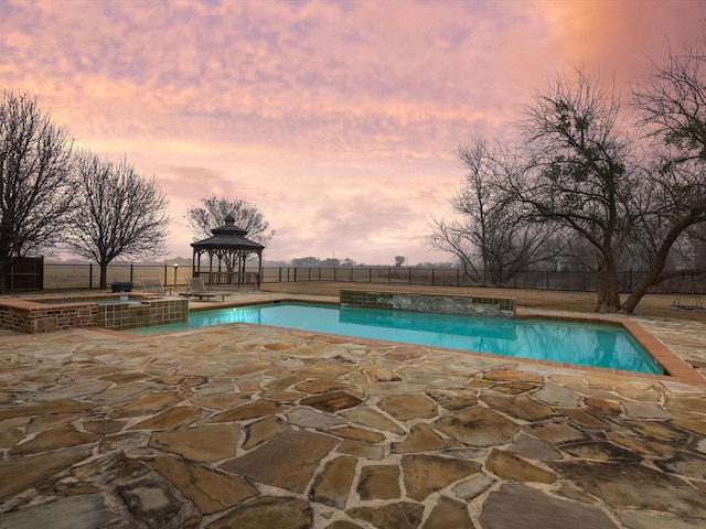 view of pool with a patio area, a fenced backyard, a pool with connected hot tub, and a gazebo