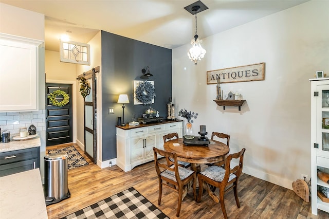 dining area featuring hardwood / wood-style floors and a barn door