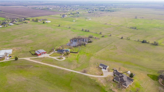 birds eye view of property with a rural view