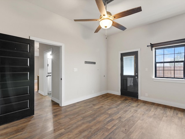 entryway featuring a ceiling fan, baseboards, and dark wood-style flooring