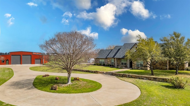 surrounding community featuring curved driveway and a yard