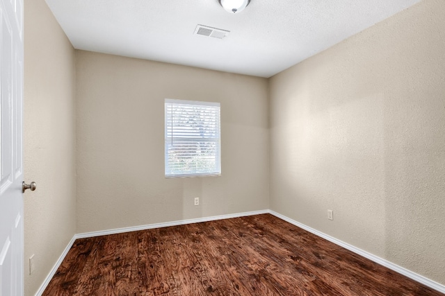 unfurnished room featuring dark hardwood / wood-style floors