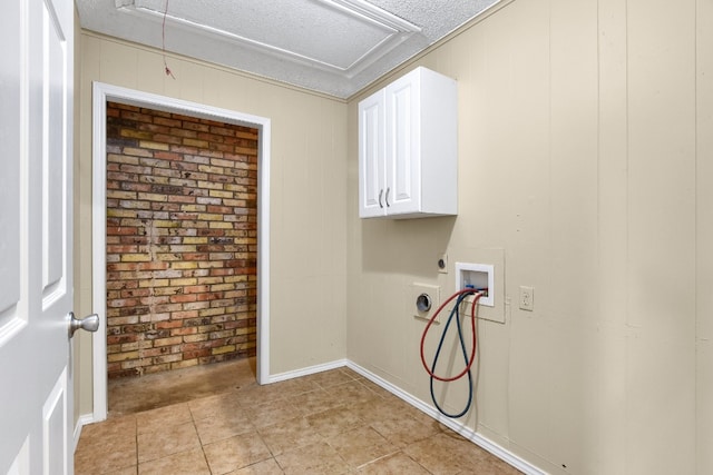 laundry area featuring hookup for a washing machine, a textured ceiling, electric dryer hookup, and light tile floors