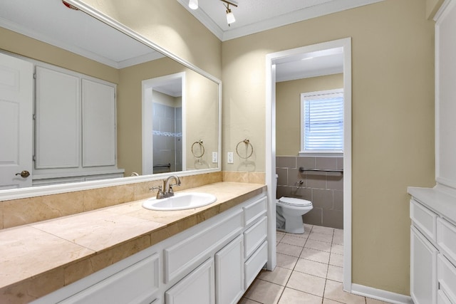 bathroom with toilet, track lighting, vanity, tile walls, and tile floors