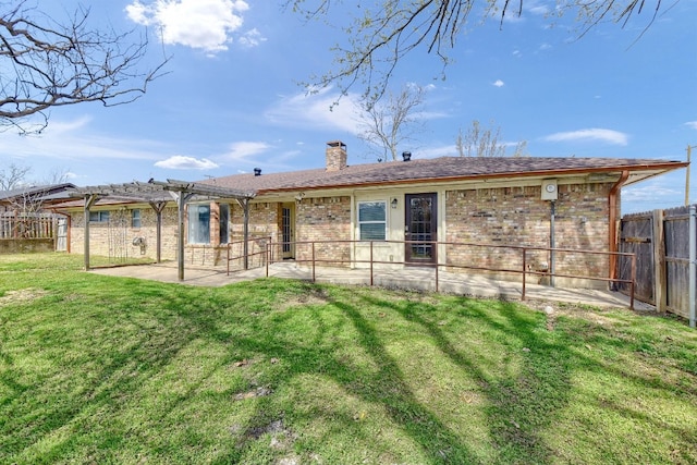 back of house with a lawn and a patio