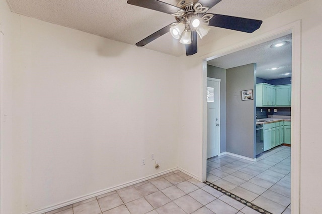 unfurnished room with ceiling fan, a textured ceiling, and light tile patterned floors