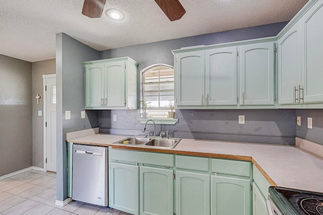 kitchen with light tile patterned flooring, sink, ceiling fan, stainless steel appliances, and a textured ceiling