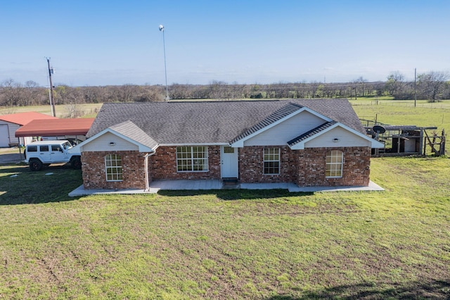 single story home featuring a carport and a front lawn