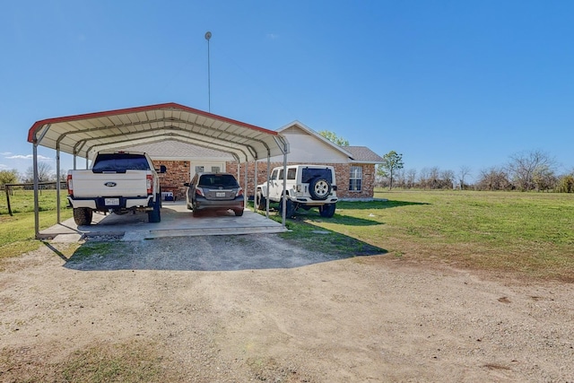 view of vehicle parking featuring a carport and a lawn