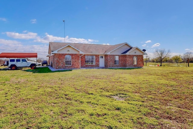 ranch-style home with a front lawn and a carport