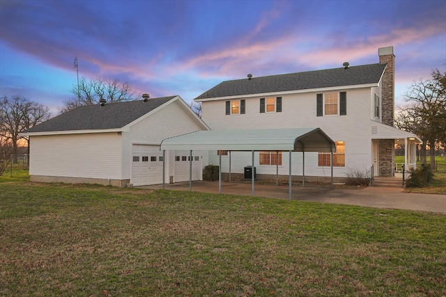 view of front of house with a garage, central AC unit, a carport, a porch, and a lawn