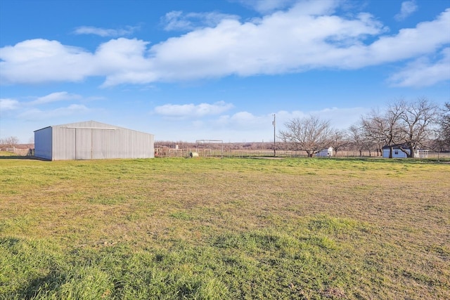 view of yard featuring an outdoor structure and a rural view