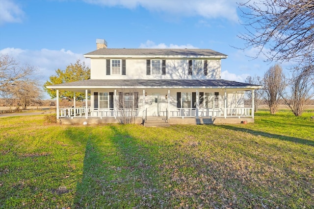 rear view of house featuring a yard