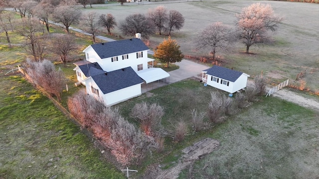 birds eye view of property with a rural view