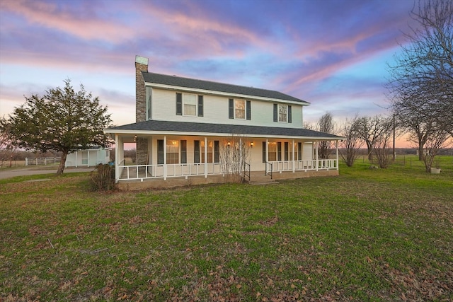 farmhouse featuring a porch and a lawn