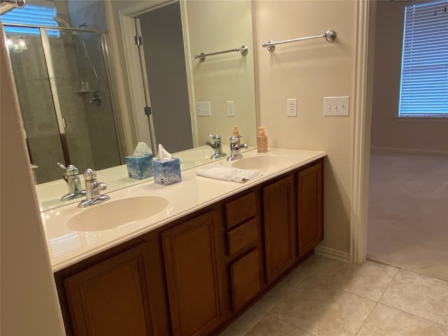 bathroom featuring a shower with door, tile floors, and dual bowl vanity