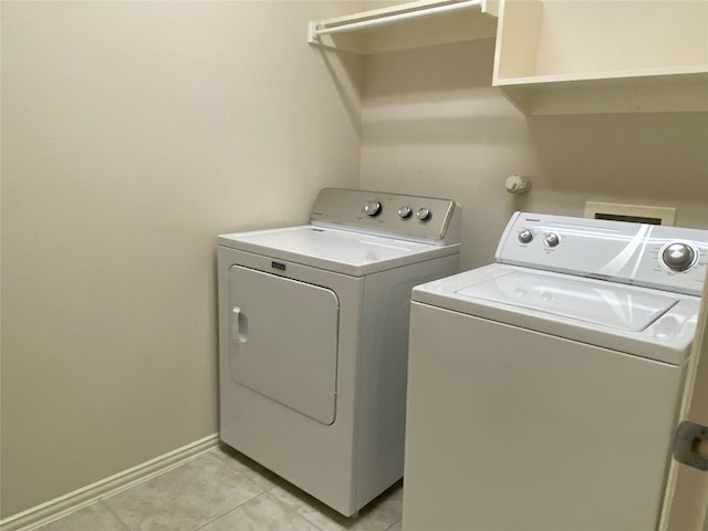 clothes washing area featuring separate washer and dryer, washer hookup, and light tile flooring