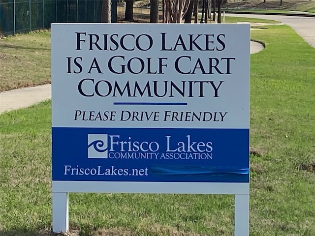 community / neighborhood sign with a lawn