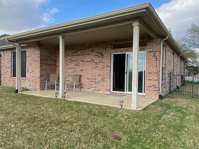 back of house featuring a lawn and a patio