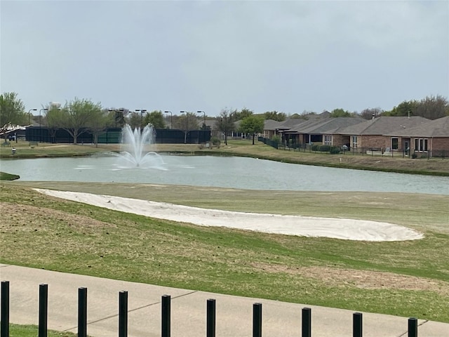 view of home's community featuring a water view and a yard