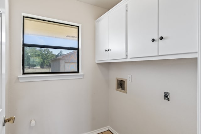 clothes washing area featuring electric dryer hookup, cabinets, and hookup for a washing machine