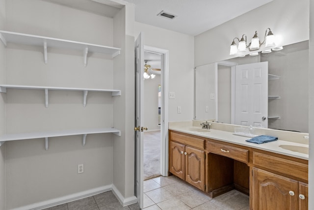 bathroom featuring double vanity, tile patterned flooring, and ceiling fan