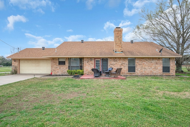 exterior space with a garage and a lawn