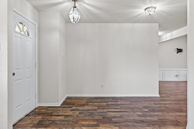 entryway with a textured ceiling and hardwood / wood-style floors