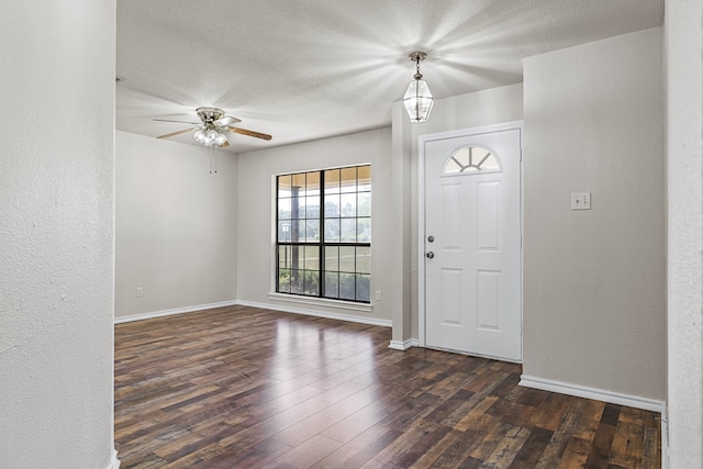 foyer featuring dark hardwood / wood-style floors, a textured ceiling, and ceiling fan