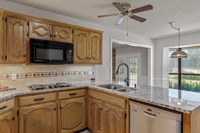 kitchen featuring sink, dishwashing machine, decorative light fixtures, and kitchen peninsula