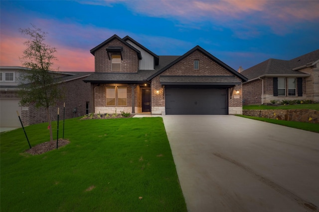 view of front of house featuring a garage and a yard