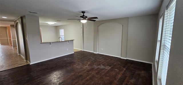 empty room featuring ceiling fan, dark wood-type flooring, and sink