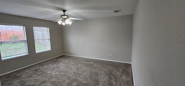 carpeted spare room featuring ceiling fan