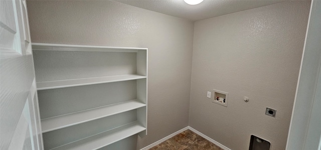 laundry room featuring dark tile flooring, electric dryer hookup, washer hookup, and gas dryer hookup